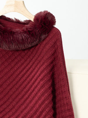 Burgundy knit poncho with faux fur trim and diagonal ribbing detail.