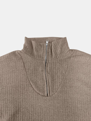 Ribbed knit quarter-zip pullover sweater in taupe with a mock neck and silver zipper detail.