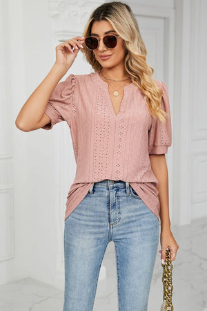 Pink perforated puff sleeve keyhole blouse with v-neck and eyelet detail.