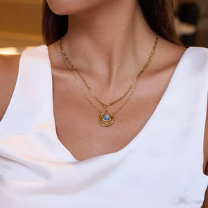 Elegant 18k gold-plated layered pendant necklace with blue stone detail.