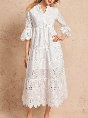 White eyelet tiered midi dress with button front, flared sleeves, and scalloped hem.