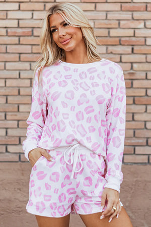 Pink leopard print loungewear set with long sleeve top and drawstring shorts.