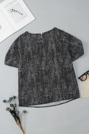 Black dotted puff sleeve blouse with crew neck and short sleeves.