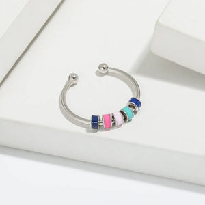 Open-band ring with colorful beads in navy, pink, light pink, light blue, and teal on sterling silver.