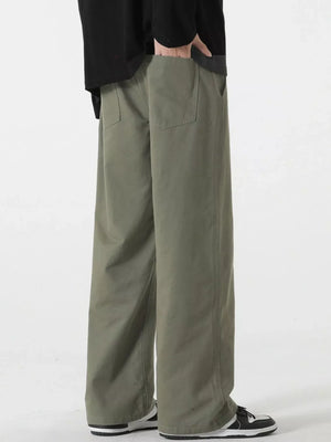 Relaxed fit drawstring pants in Military Green with back pockets.