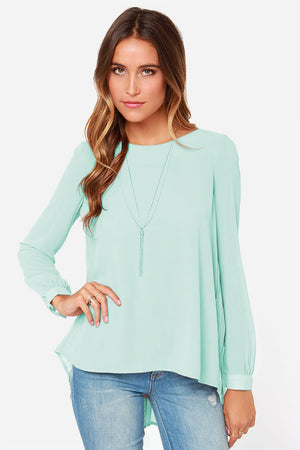 Light green long sleeve blouse with fluid silhouette and pleated backline detail.