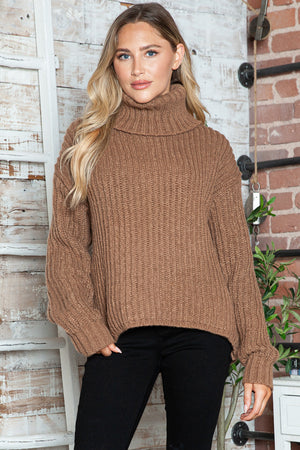Brown chunky ribbed turtleneck sweater with relaxed fit and long sleeves.