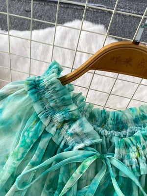 Light green floral bikini top with ruffled neckline and bow detail.