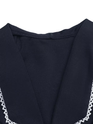 Navy lace-trimmed tie-front vest with V-neckline.