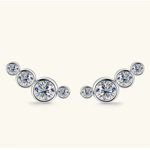 Silver ear climbers with five round, sparkling crystals in a graduated cluster design.