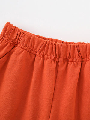 Toddler orange cotton shorts with elastic waistband detail