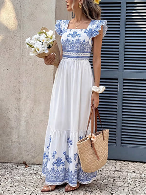 Printed square neck maxi dress with blue and white bohemian pattern, ruffled sleeves, and tiered skirt.