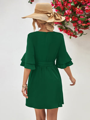 Forest green tiered sleeve mini dress with tie waist and A-line cut.