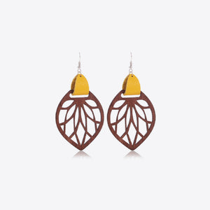 Leaf cutout wood dangle earrings with yellow leather accent.