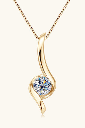 Gold moissanite pendant necklace with a swirling design and a round-cut stone.