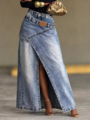 Asymmetrical high-waisted denim maxi skirt with a front slit and distressed details.