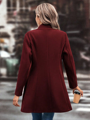 Burgundy wool coat with flared hemline and button detail, shown from the back.