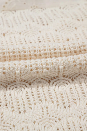 Beige crochet knit vest with eyelet yoke detail and open knit pattern.
