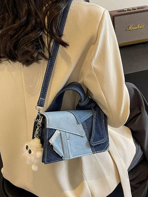 Artisanal mini denim crossbody bag with patchwork design and fluffy keychain.