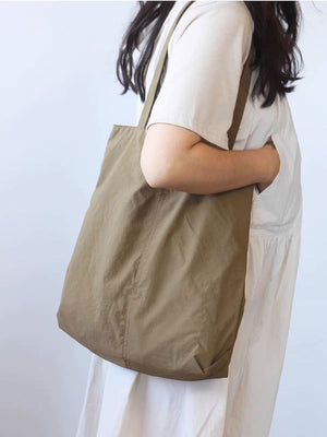 Spacious Khaki Nylon Shoulder Bag with slip pocket detail.