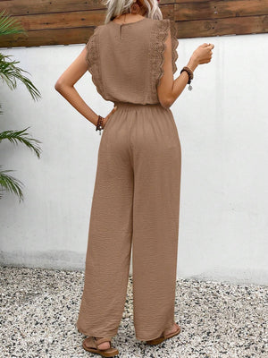 Textured ruffle sleeve jumpsuit in taupe with wide legs and drawstring waist.