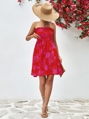 Smocked bandeau floral mini dress in red with pink flowers, A-line cut, strapless, cinched waist.