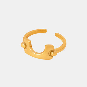 Sculptural gold open-ended ring with asymmetrical design and ball accents.