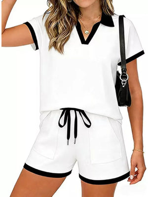 White polo collar two-piece set with black trim, drawstring shorts with pockets.