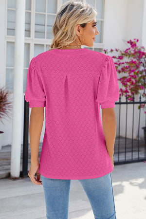 Hot Pink eyelet V-neck blouse with puff sleeves and a relaxed fit.