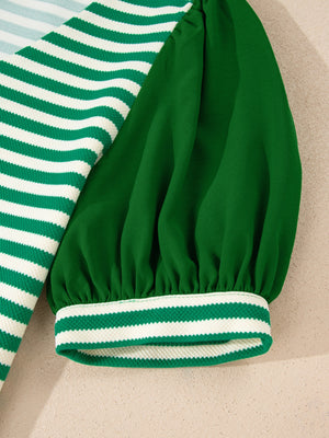 Striped puff sleeve shirt with green and white stripes and a green sleeve.