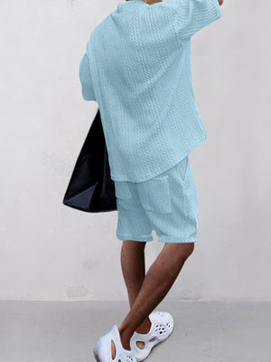 Sky blue cable-knit v-neck two-piece set with short sleeves and shorts.
