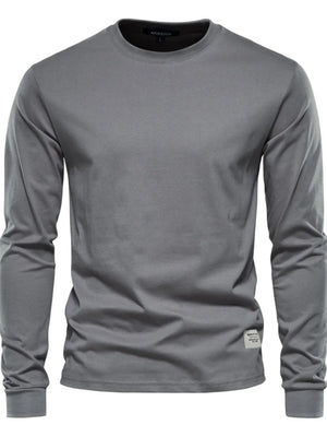 Gray crewneck long sleeve t-shirt with a small woven label detail on the hem.