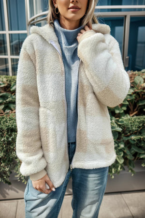 Sherpa zip-up jacket with buffalo check pattern in cream and tan, featuring a hood and pockets.