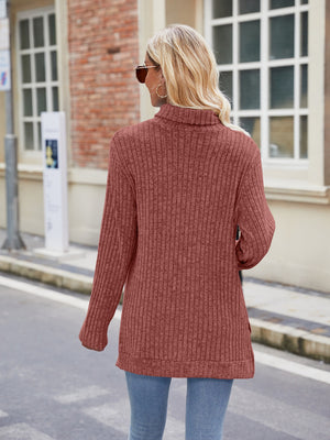 Ribbed turtleneck sweater in Brick Red with side slits and long sleeves.