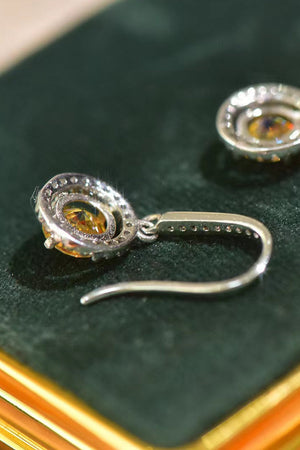 Golden halo moissanite drop earrings with yellow and white stones.