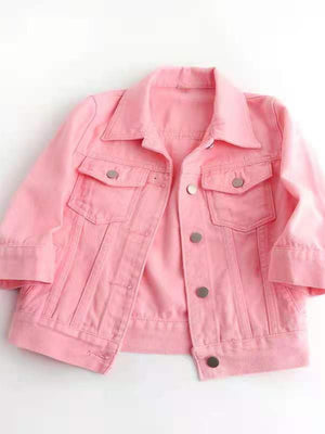 Pink denim trucker jacket with cropped sleeves and button front.