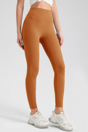 Caramel high-waist performance leggings with sculpting seams.
