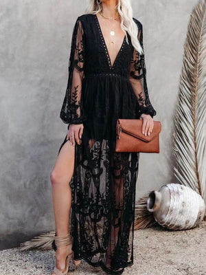 Black lace maxi dress with plunging neckline, long sheer sleeves, and high slit.