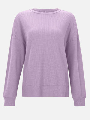 Lavender waffle knit relaxed fit crewneck top with long sleeves and ribbed cuffs and hem.