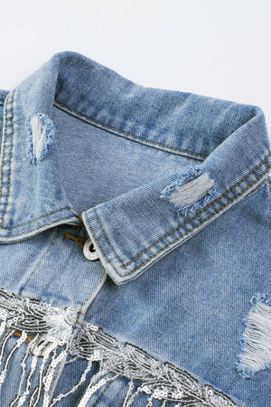 Medium wash denim trucker jacket with distressed details and sequin fringe.