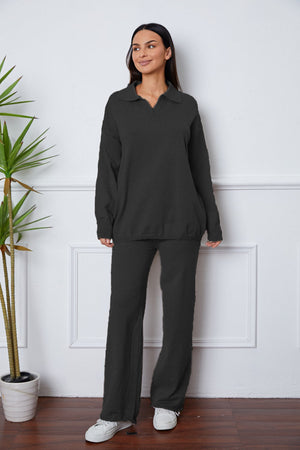 Black knit polo co-ord set with relaxed fit sweater and wide leg pants.