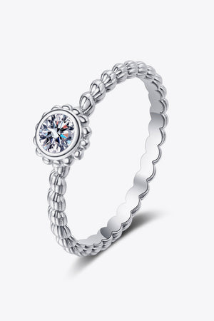 Silver beaded band ring with a moissanite solitaire stone and scalloped edge.
