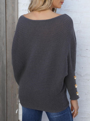 Dark Gray batwing knit sweater with boat neck and pearl button cuff details.