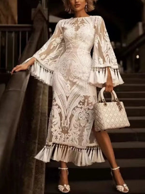 White lace midi dress with bell sleeves, tassel hem, and ornate pattern.
