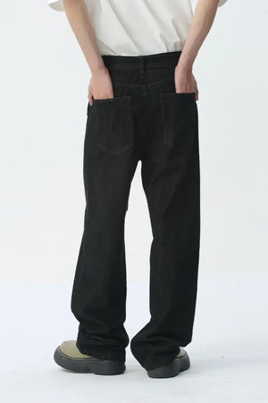 Black wide-leg denim jeans with belt detail and back pockets.