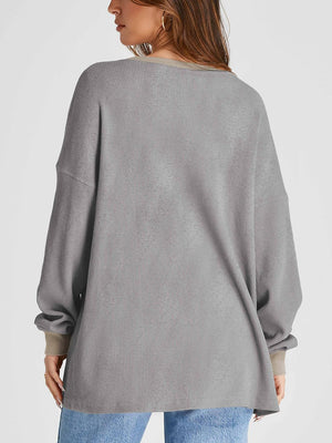 Gray waffle knit raglan sleeve sweatshirt with tan cuffs and neckline detail.
