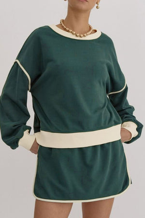 Dark green sweatshirt and skort set with cream contrast trim and neckline.