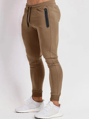 Camel slim fit tech joggers with zip pocket and drawstring.