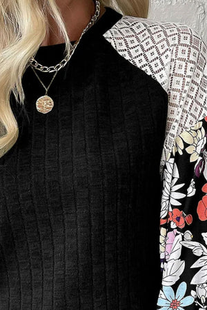 Black ribbed top with lace and floral print sleeves, crew neck, casual style.
