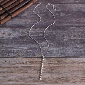 Delicate white beaded pendant necklace with silver chain.